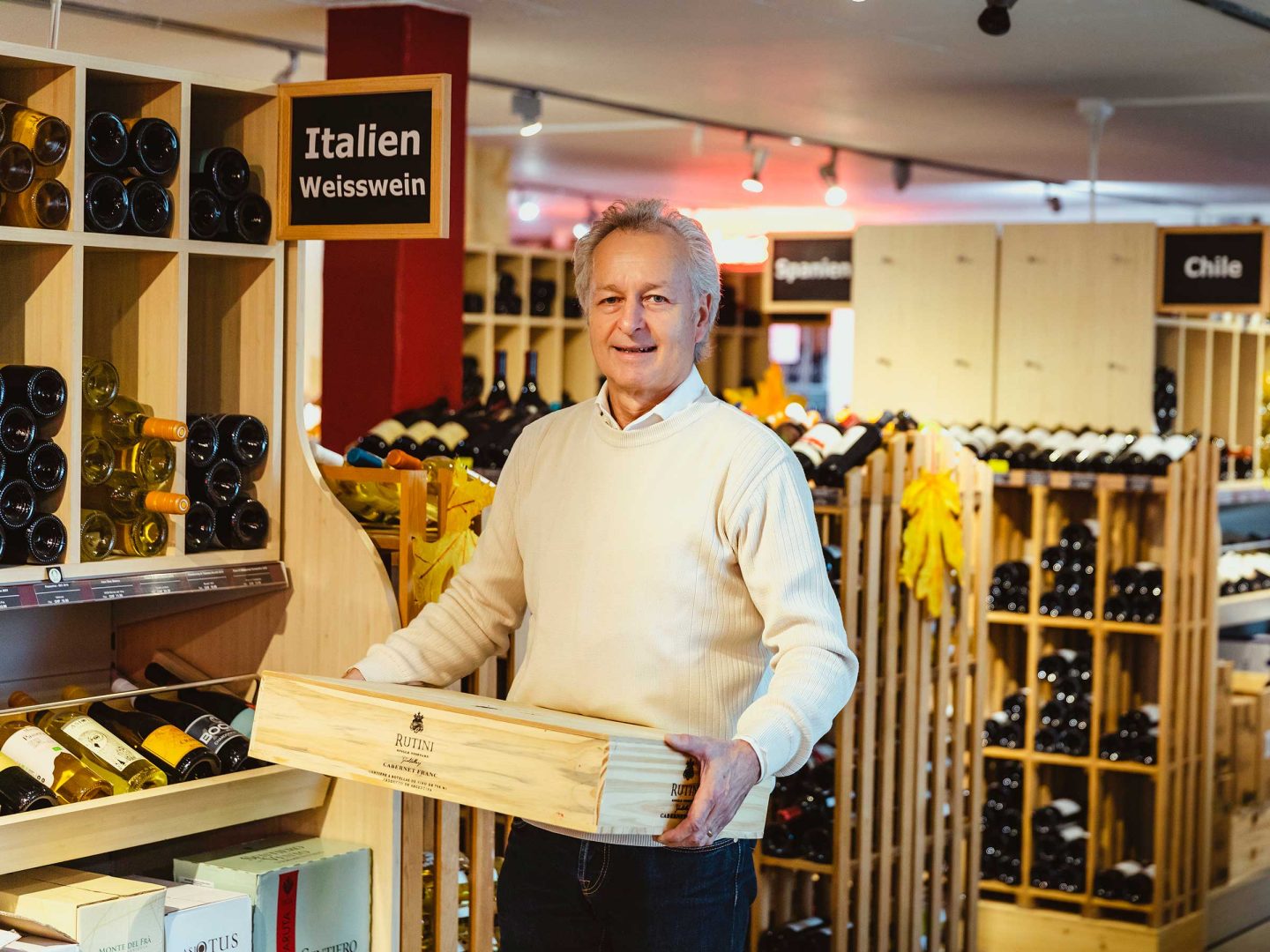 Roland Kaufmann con una cassetta di legno per il trasporto del vino.